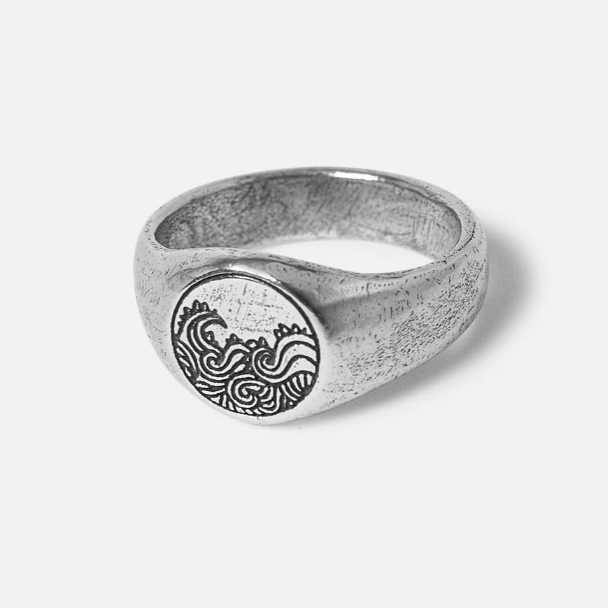 Billie Jo's sterling silver Current Ring for men, featuring a detailed, oxidised wave engraving on its circular face and a textured band.