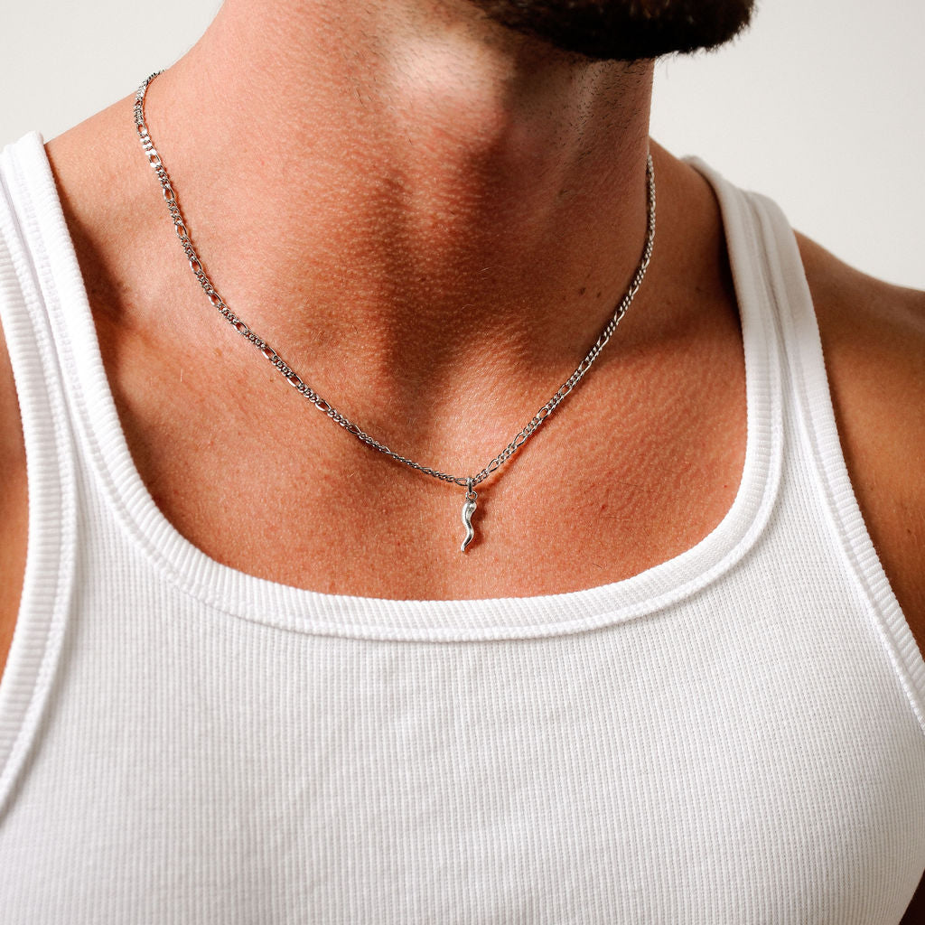 A model wears the sterling silver Billie Jo Chilli Pendant, styled with a white tank top for a modern, masculine look. The pendant sits centrally on the chest.