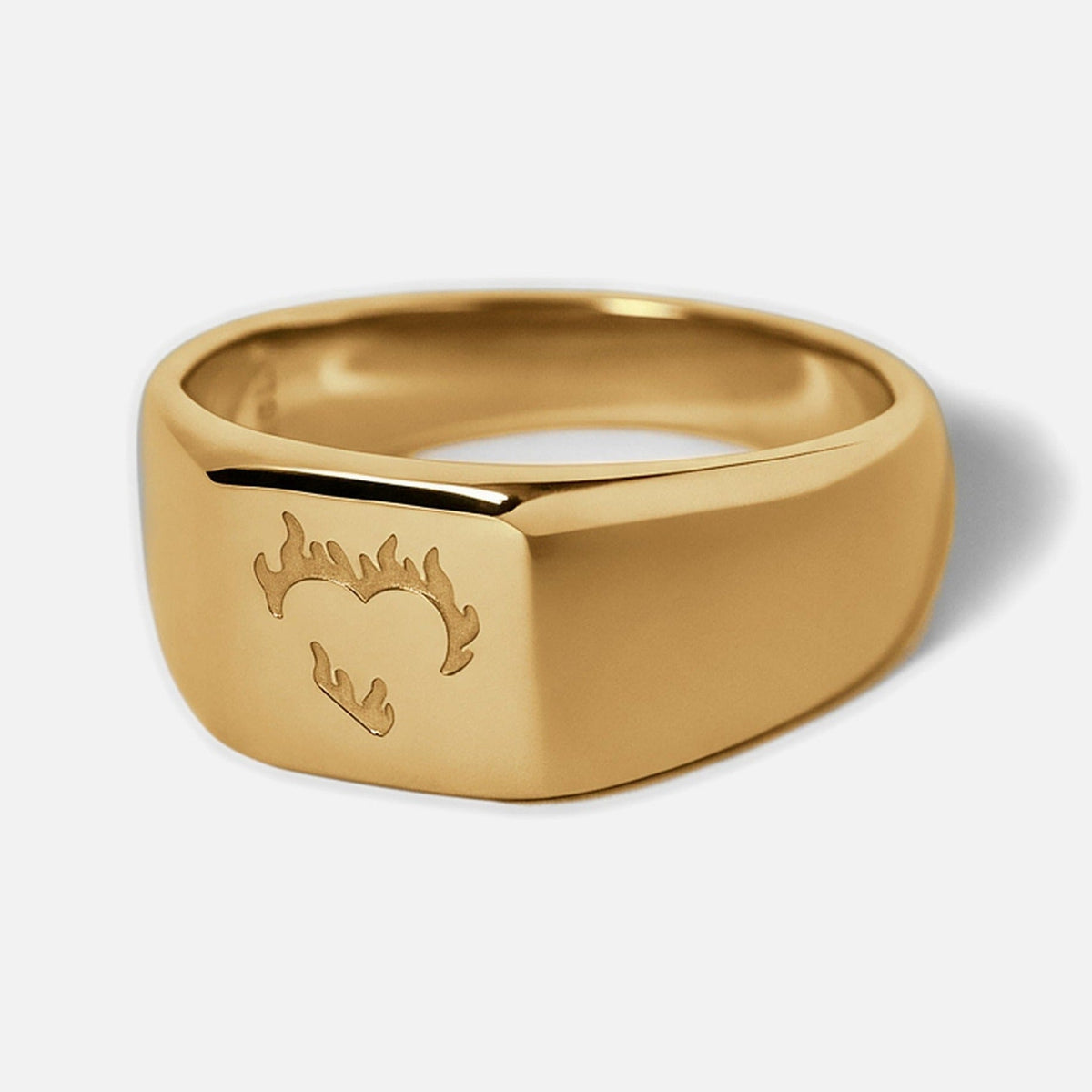 Men's Gold Ember Ring in 18k gold infused stainless steel, angled view of the flaming heart on the square face