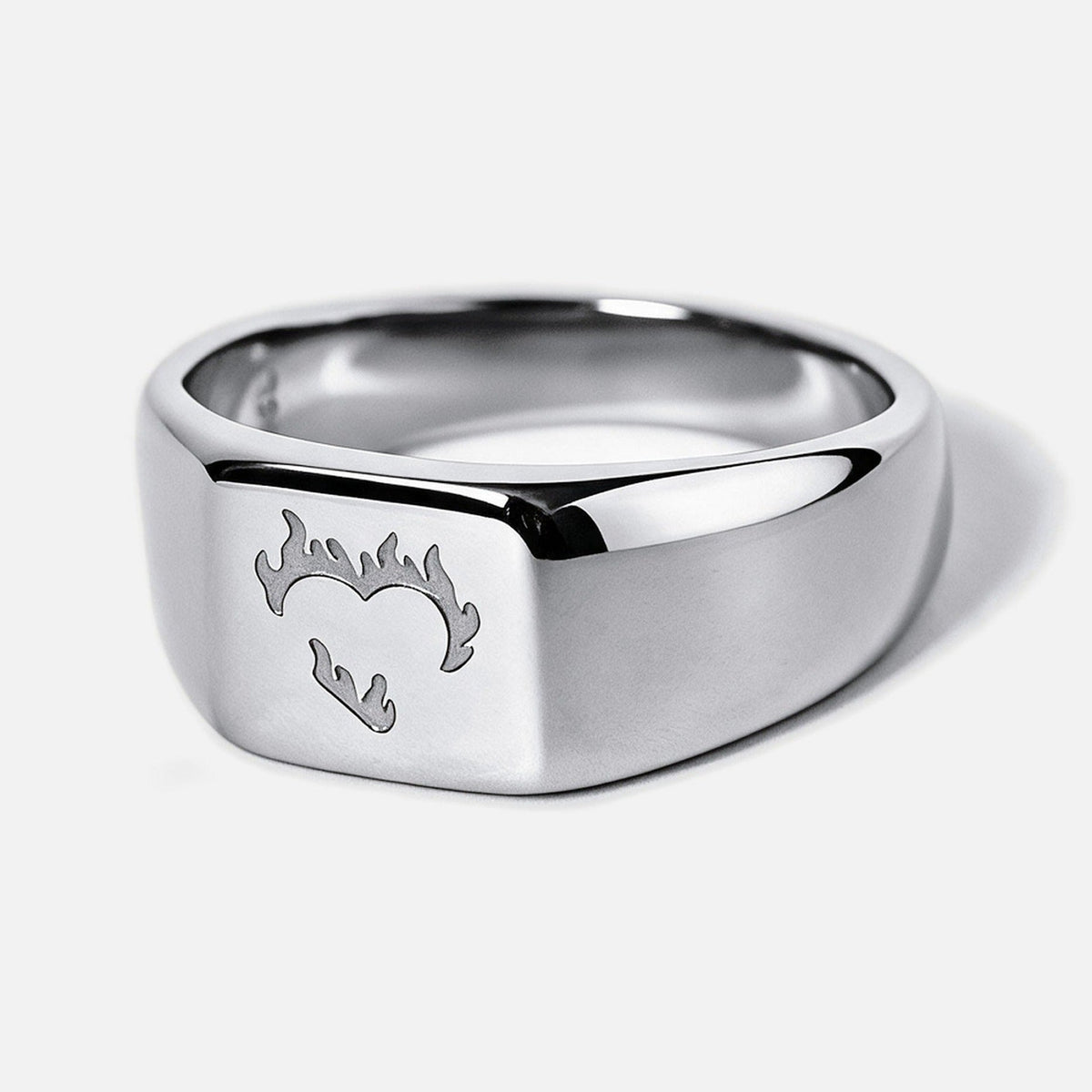 Men's Ember Ring in 316L stainless steel, silver finish, angled view of the flaming heart on the square face