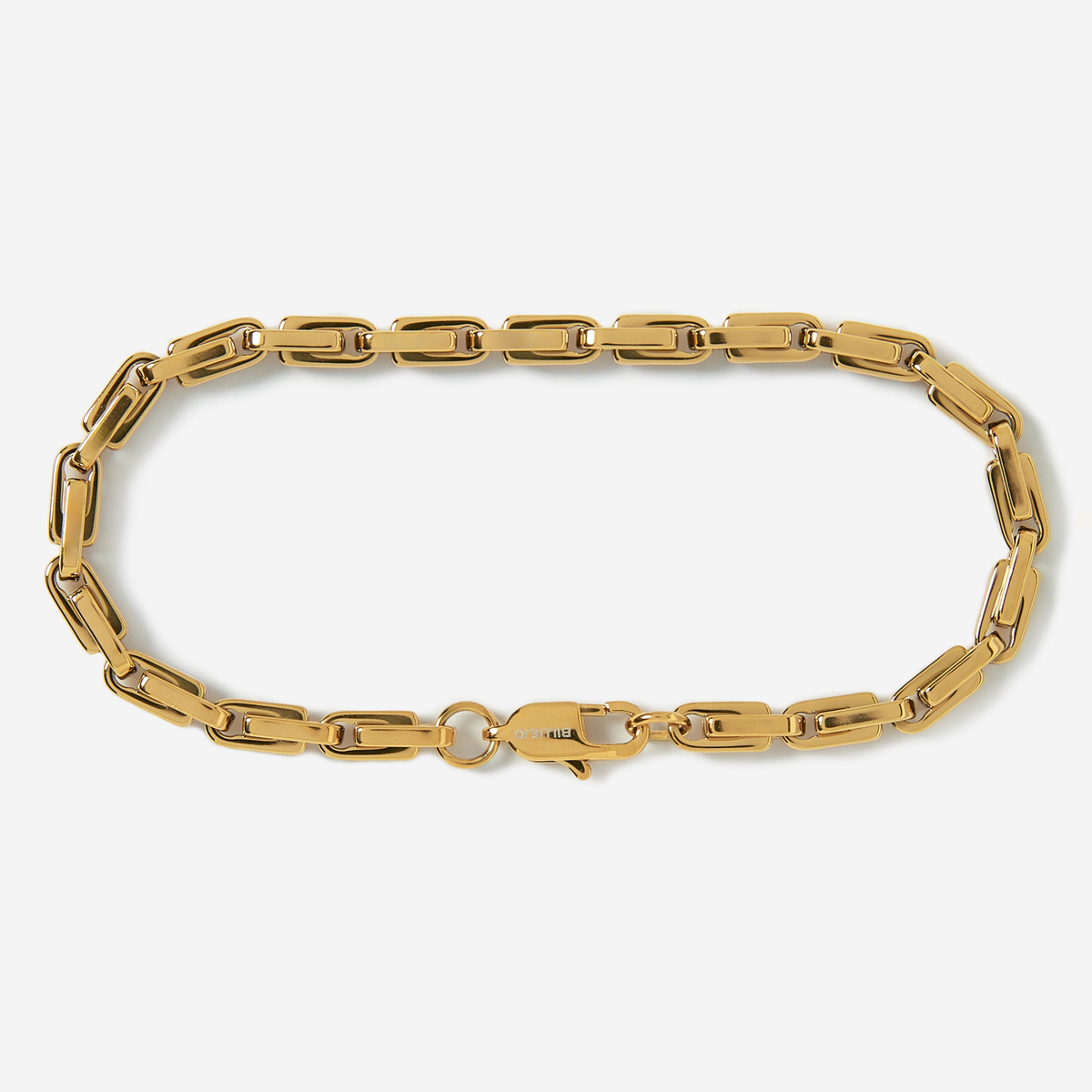 Gold chain bracelet on a light gray background