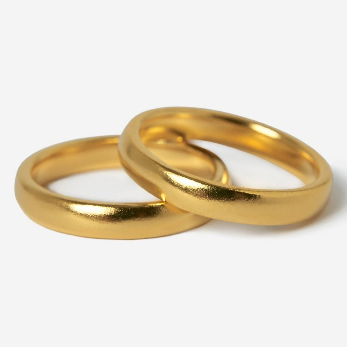 Two gold stacker rings from Billie Jo Jewellery, with a smooth, polished finish, are shown overlapping on a clean white background. The 18k gold vermeil has a warm, rich colour.