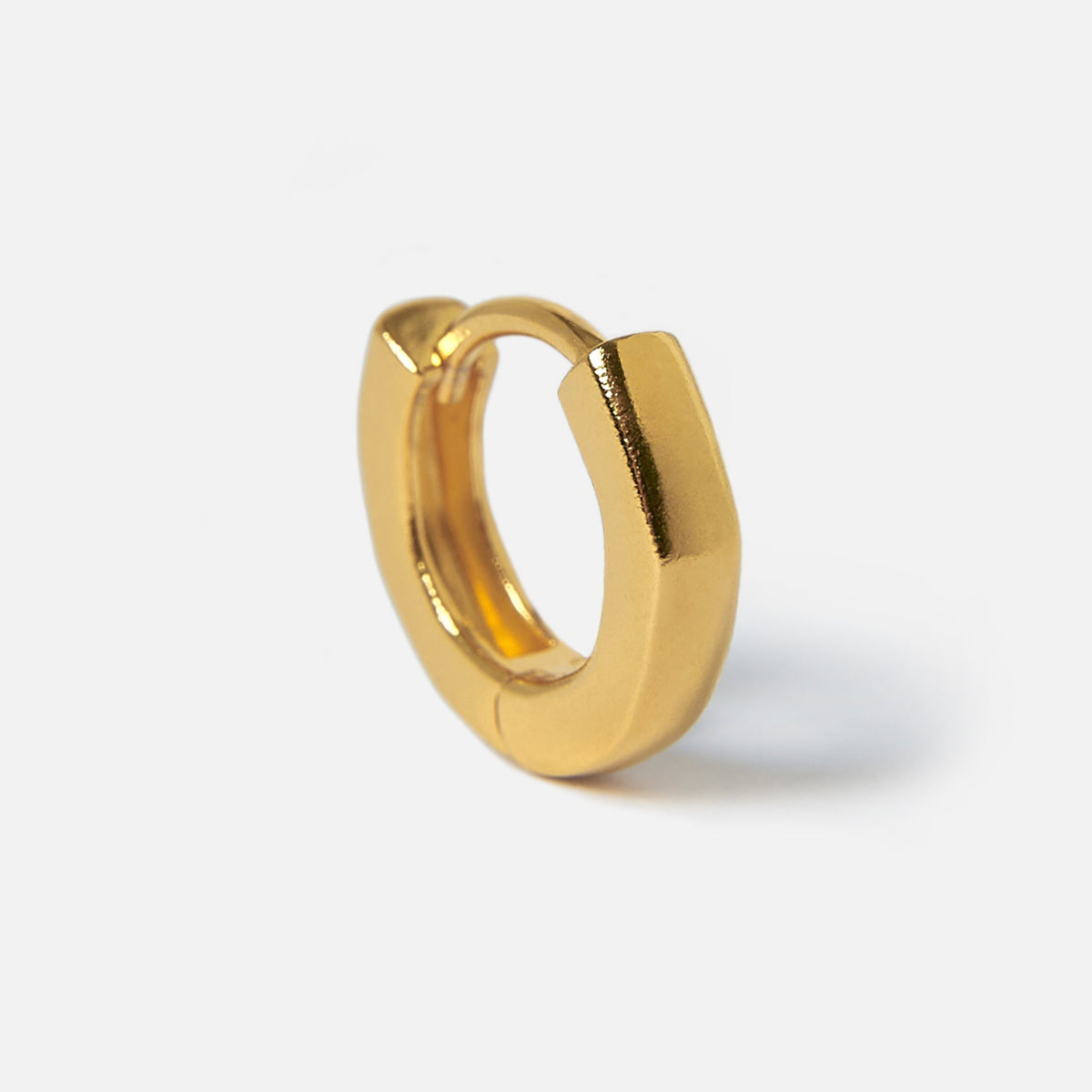 A single 18k gold vermeil Lumina Earring from Billie Jo, standing upright to showcase its unique shape and minimalist design on a white background.