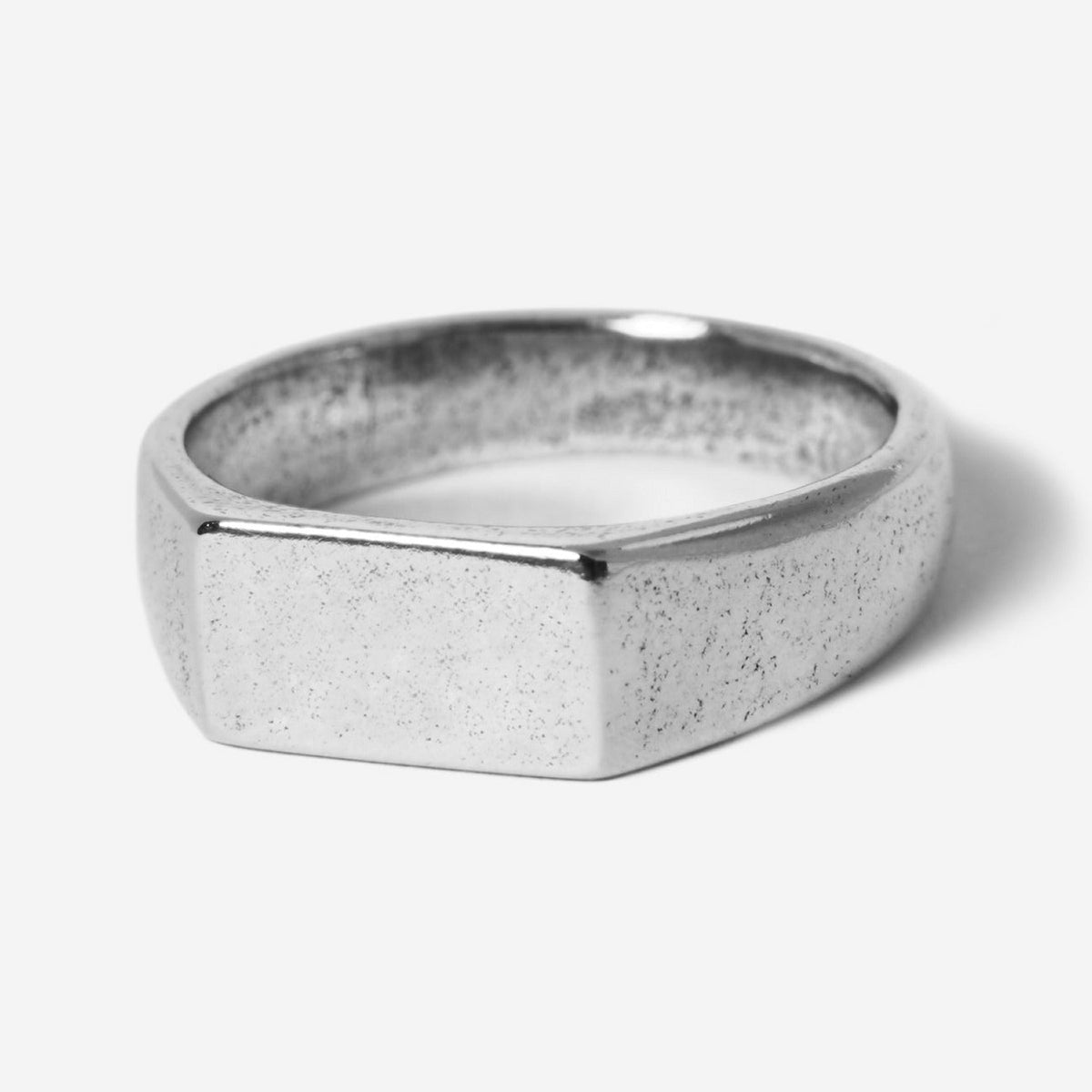 A modern men's signet ring, the Billie Jo Genesis Ring in sterling silver features a rectangular face and a unique textured finish. A timeless piece of Australian men's jewellery.