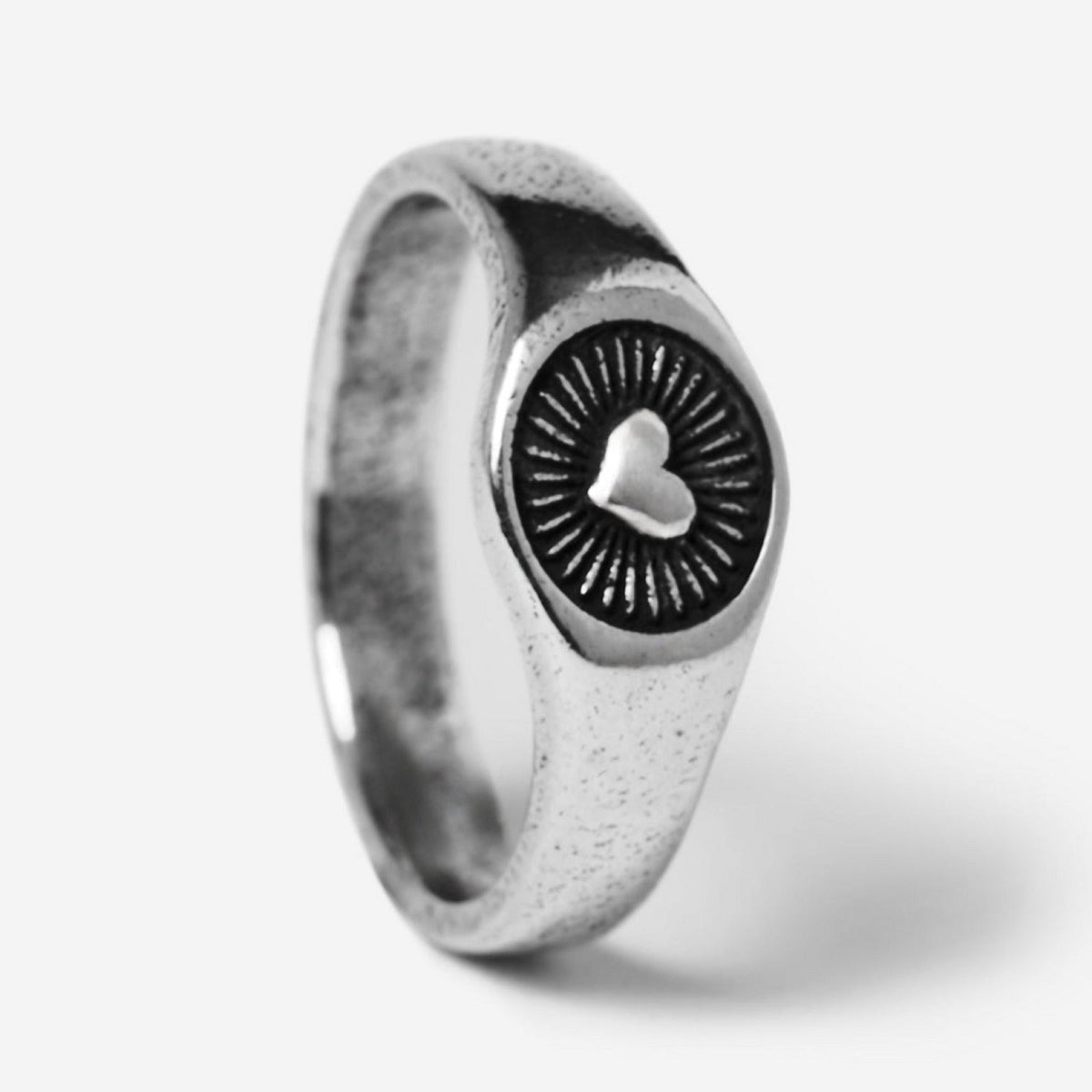 A standing, angled product shot of the sterling silver Vita Ring. This image provides a clear view of the ring's unique heart and sunburst design, a signature piece from Billie Jo men's jewellery.