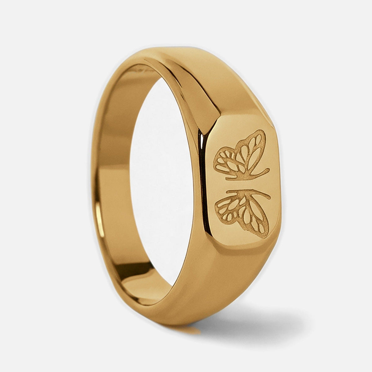 Men's Gold Revival Ring in 18k gold infused stainless steel, upright side view of the butterfly face, white background