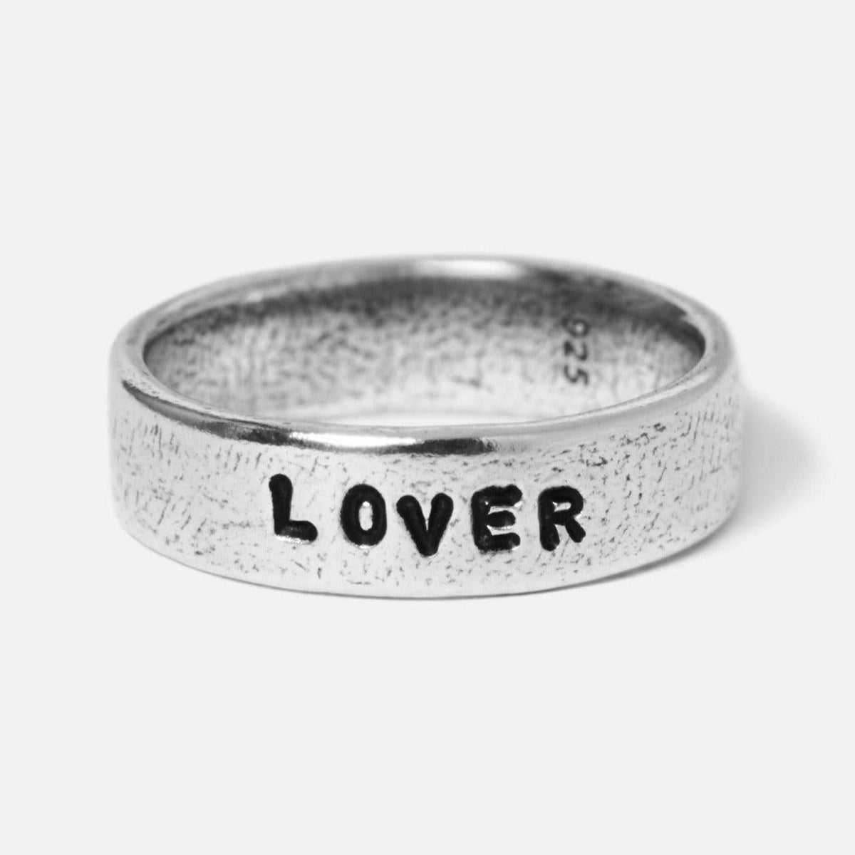 A close-up of the Billie Jo Custom Stamped Ring in sterling silver, featuring the word '''LOVER''' hand-stamped for a unique, personal touch.