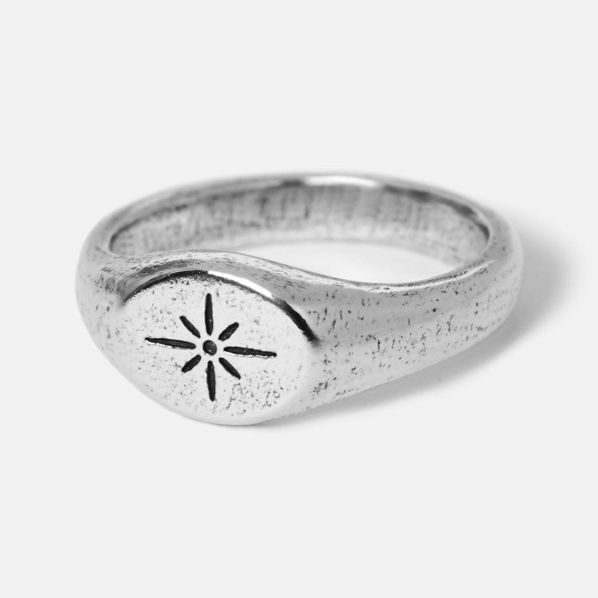 A men's sterling silver signet ring, the Luminous Ring by Billie Jo, with a textured finish and a central starburst engraving. Australian jewellery.