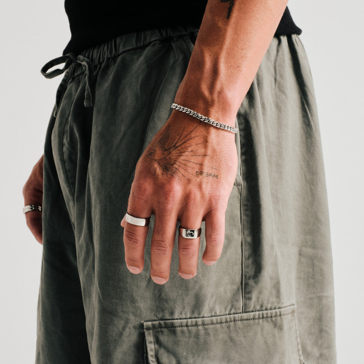 Men's Canvas Ring in 316L stainless steel, silver finish, worn on the index finger, hand hanging by his side
