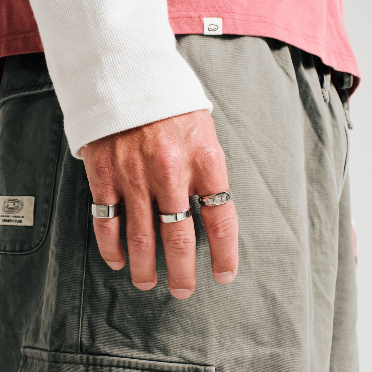 Men's Ember Ring in 316L stainless steel, silver finish, worn on the ring finger, hand hanging by his side