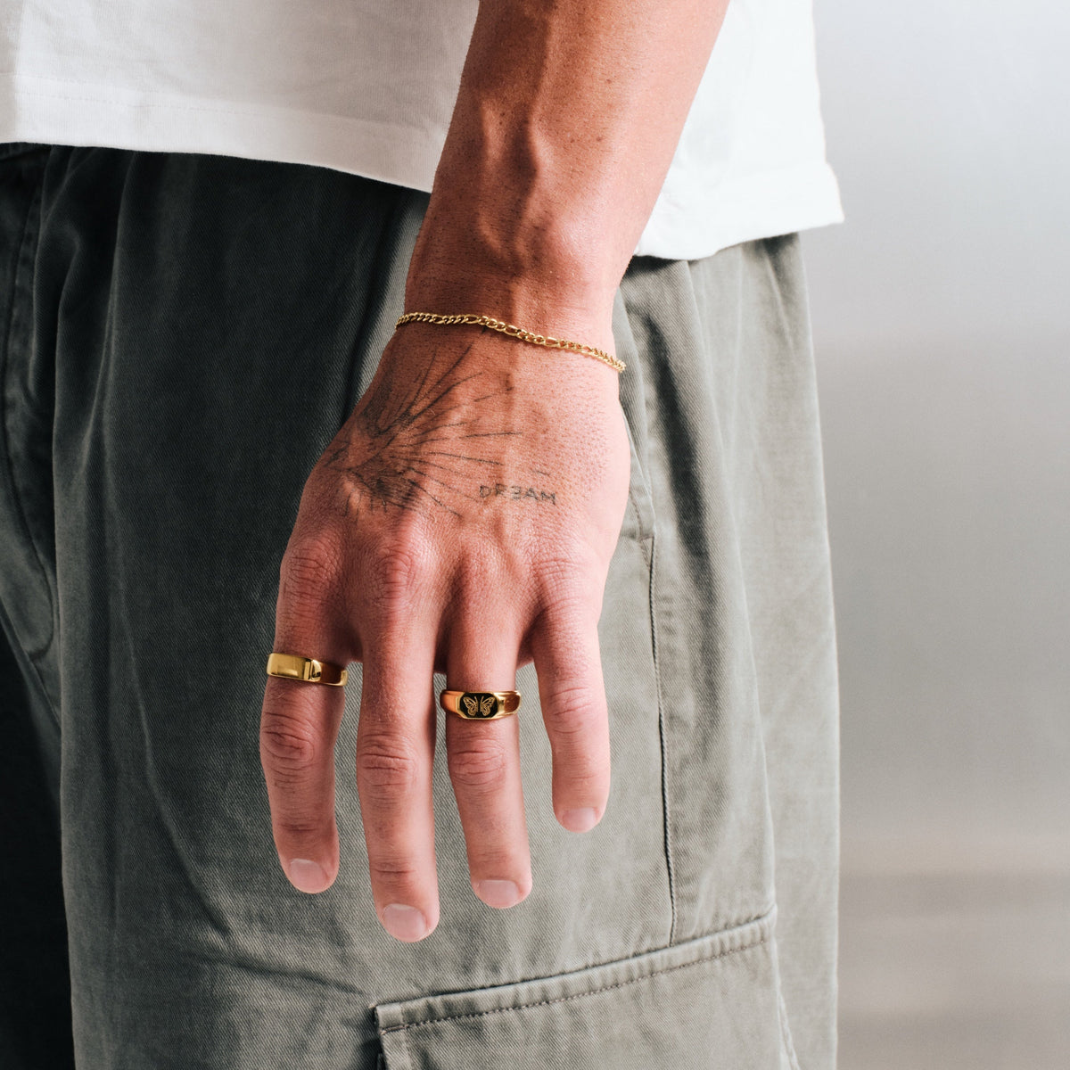 Men's Gold Revival Ring in 18k gold infused stainless steel, worn on the ring finger, hand hanging at his side