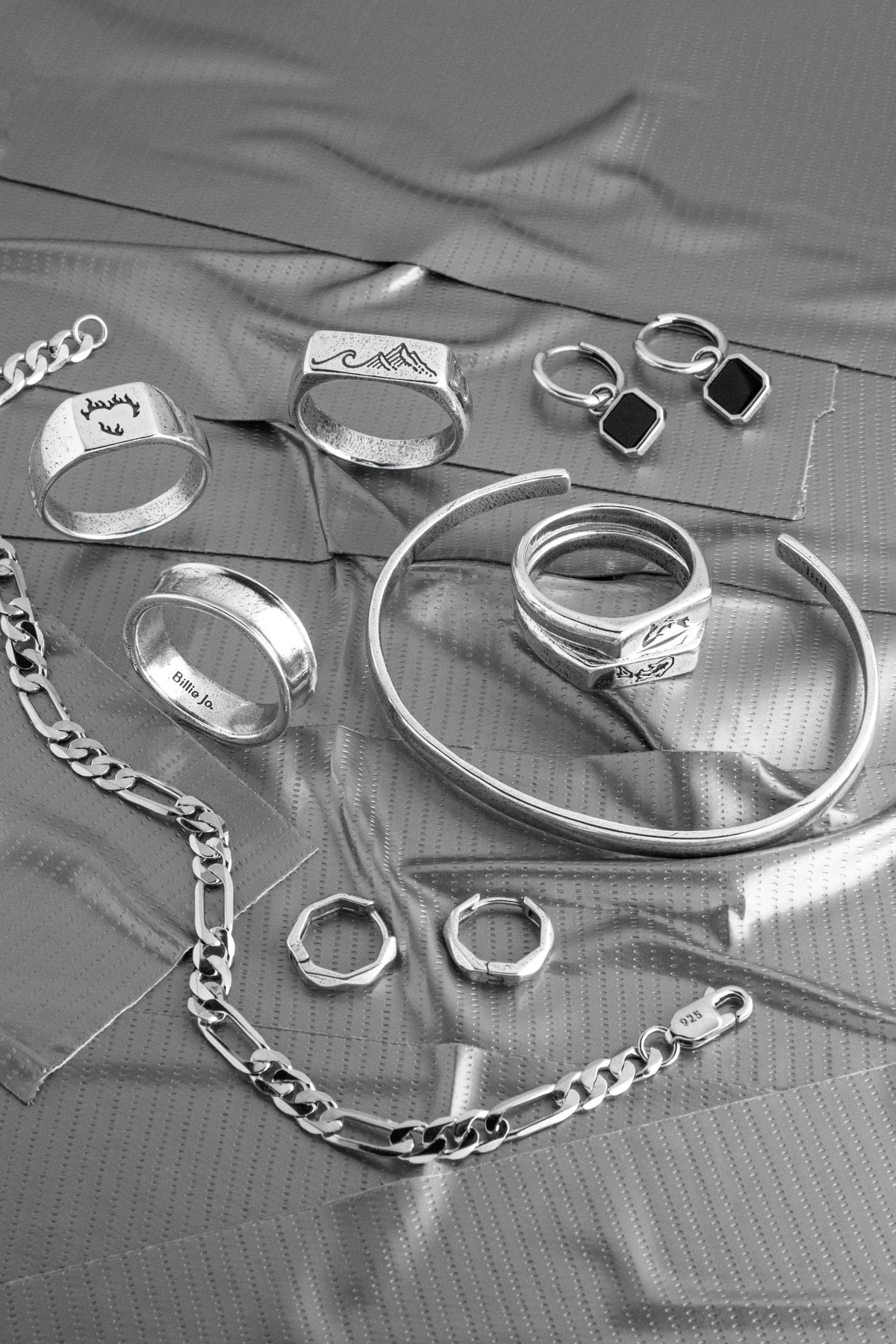  Mens jewellery gift guide flat lay of Billie Jo sterling silver rings, chains and bracelets being chosen as a gift for him