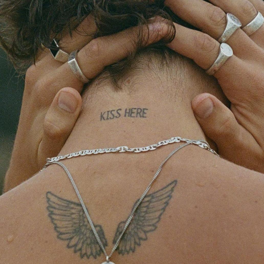 A close-up editorial shot of a man's neck, showing the sterling silver chain of the Billie Jo Untold Pendant layered with other jewellery.