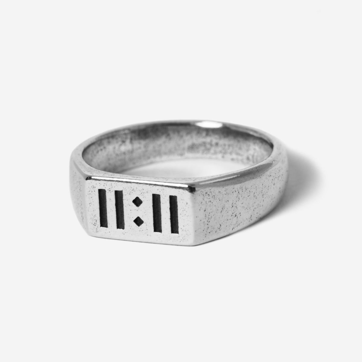 A sterling silver signet ring, the Momento Ring by Billie Jo, featuring a modern design with '11:11' engraved on its face. A piece of Australian men's jewellery.