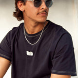 A man with a moustache and sunglasses wears the Billie Jo Rope Necklace, paired with a black t-shirt for a casual, everyday look.