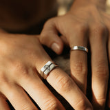 Detailed on-hand view of the Billie Jo Connection Stackers, a set of two sterling silver rings with a unique black engraved pattern.