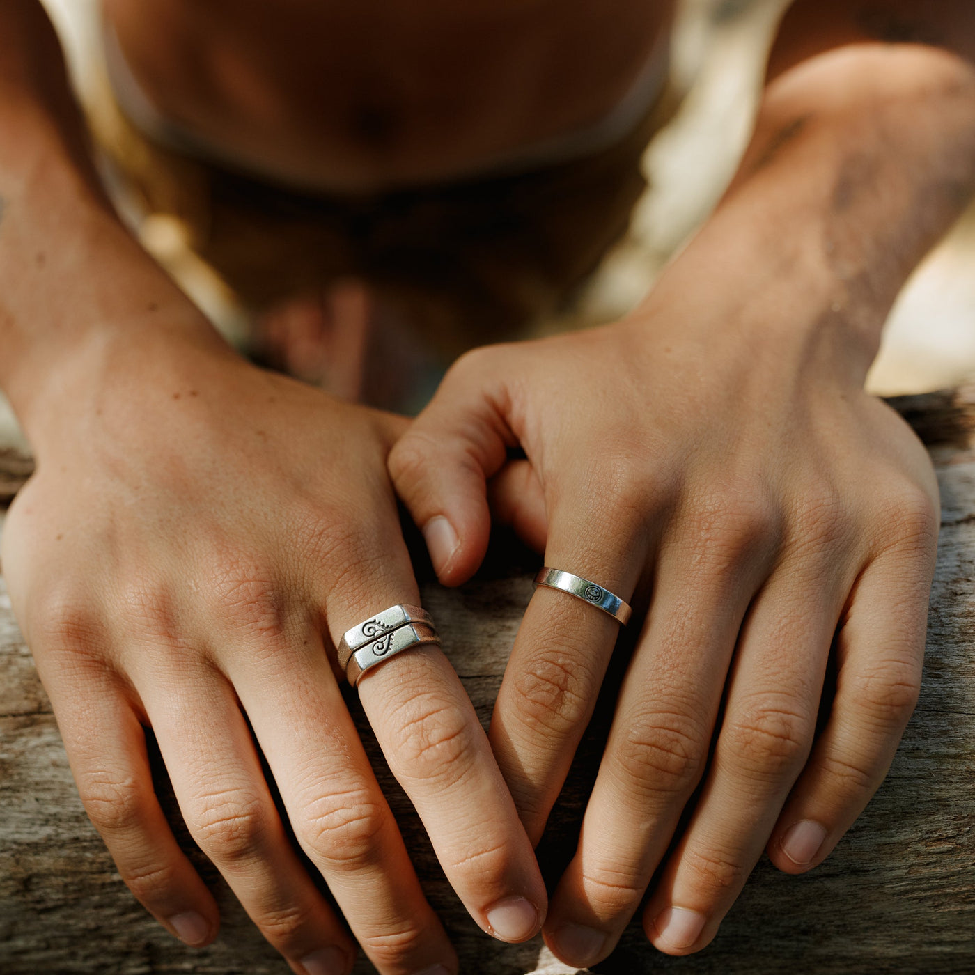 A man wearing the Billie Jo Reflection Ring on his index finger, styled with another silver ring. This lifestyle shot shows the ring in a natural, masculine context.