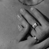 A man's hands with the Billie Jo Connection Stackers rings, in a black and white editorial shot. Australian men's jewellery.