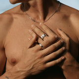 A shirtless man with a silver chain and the Billie Jo Connection Stackers rings, showcasing a modern, masculine look. Australian designed jewellery.