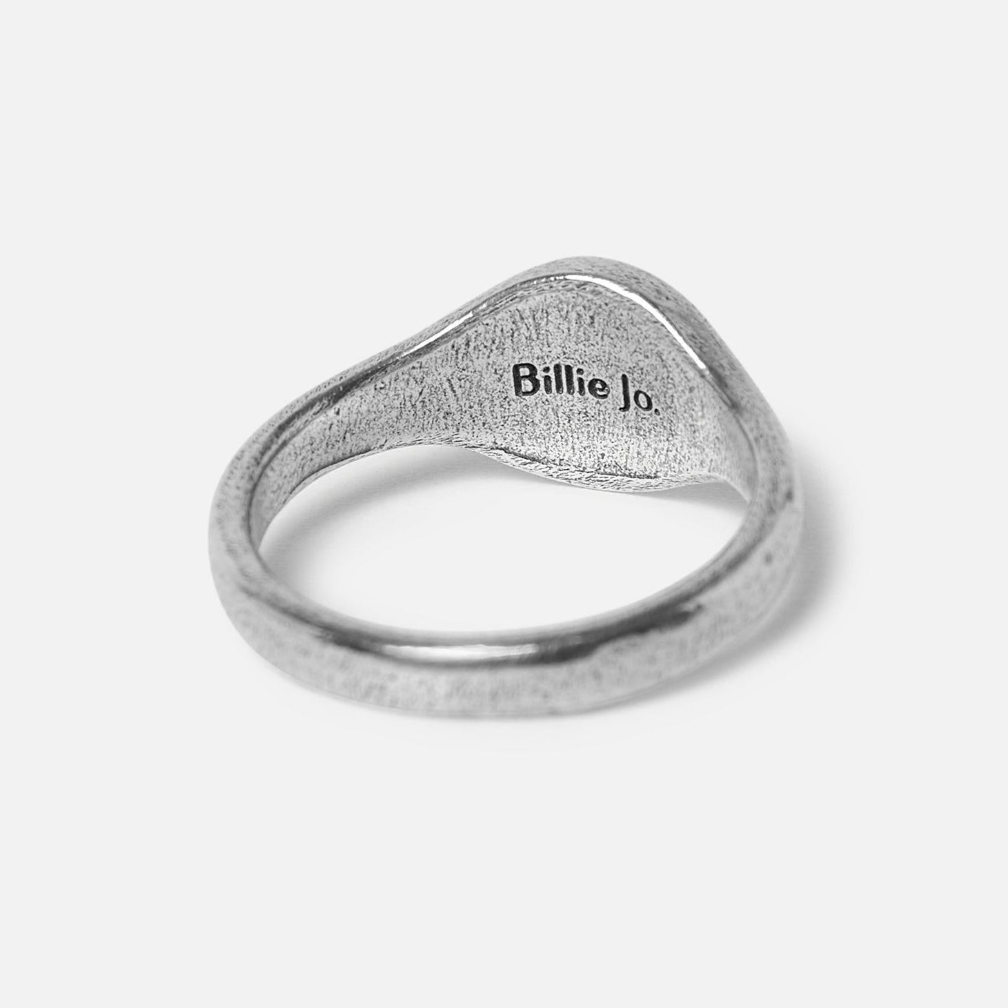A product shot of the Solace Ring from a different angle, highlighting the texture and shape of the 925 sterling silver band. Designed by Billie Jo.