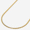 Gold rope chain necklace on a white background