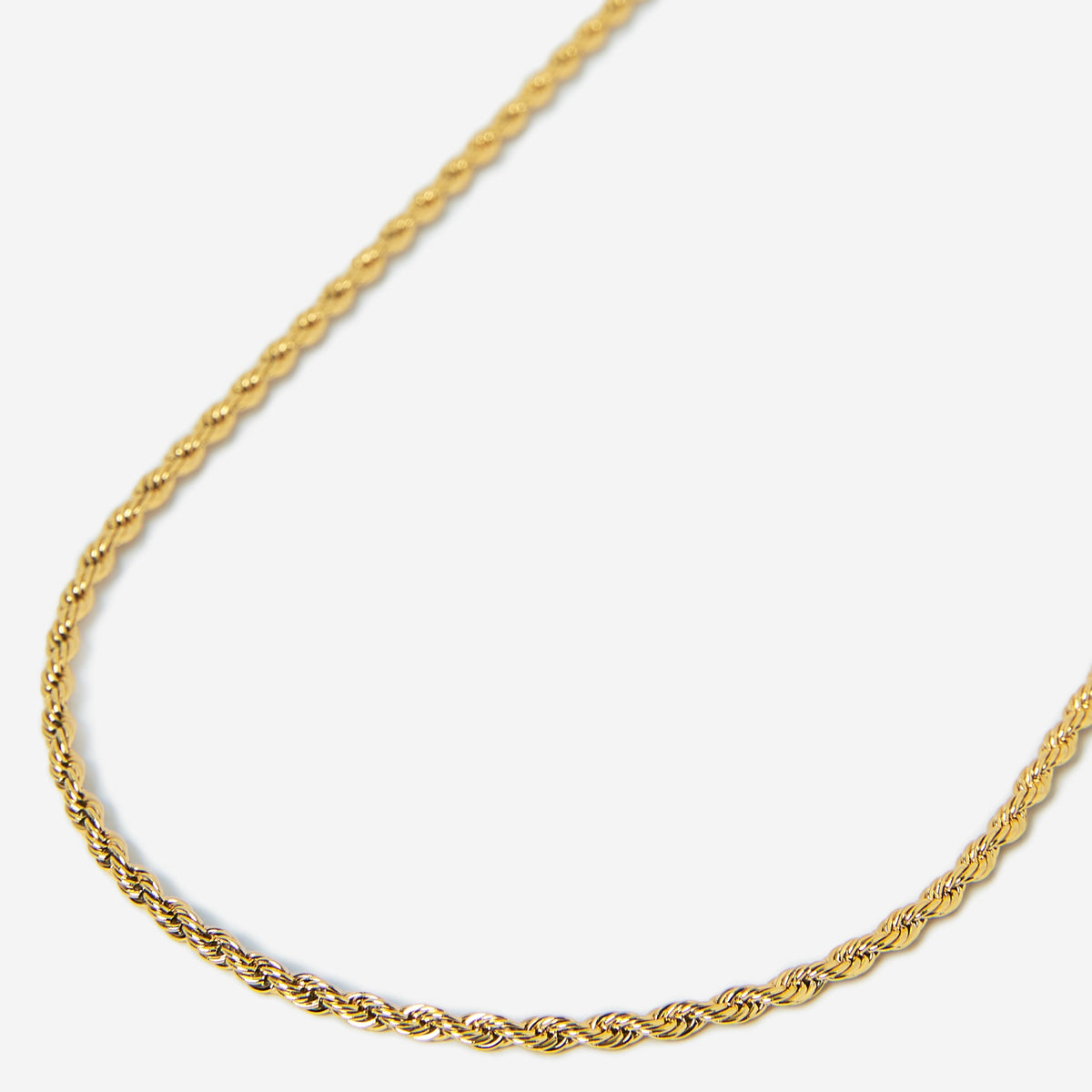 Gold rope chain necklace on a white background