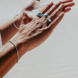A final shot of the Billie Jo Rope Bracelet, worn on a man's wrist and styled with a silver cuff and rings, capturing the brand's signature layered look.