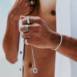 An editorial campaign shot for Billie Jo featuring a man in a desert setting, wearing the Drifter Cuff and other sterling silver jewellery pieces.