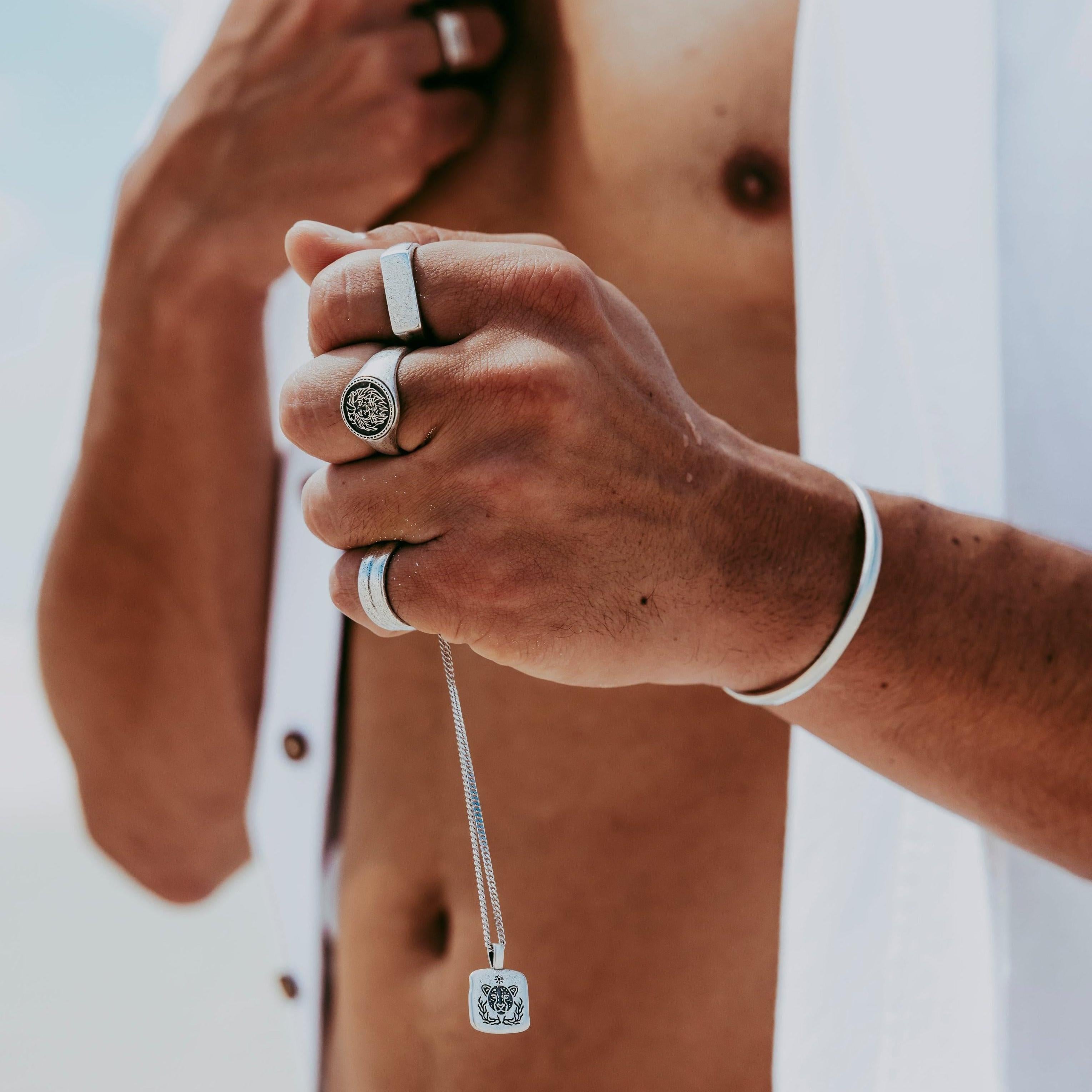 An editorial campaign shot for Billie Jo featuring a man in a desert setting, wearing the Drifter Cuff and other sterling silver jewellery pieces.