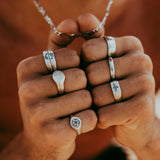 The Billie Jo Solace Ring styled on a model's hand, demonstrating how this sterling silver signet ring can be worn daily. Australian men's jewellery brand.