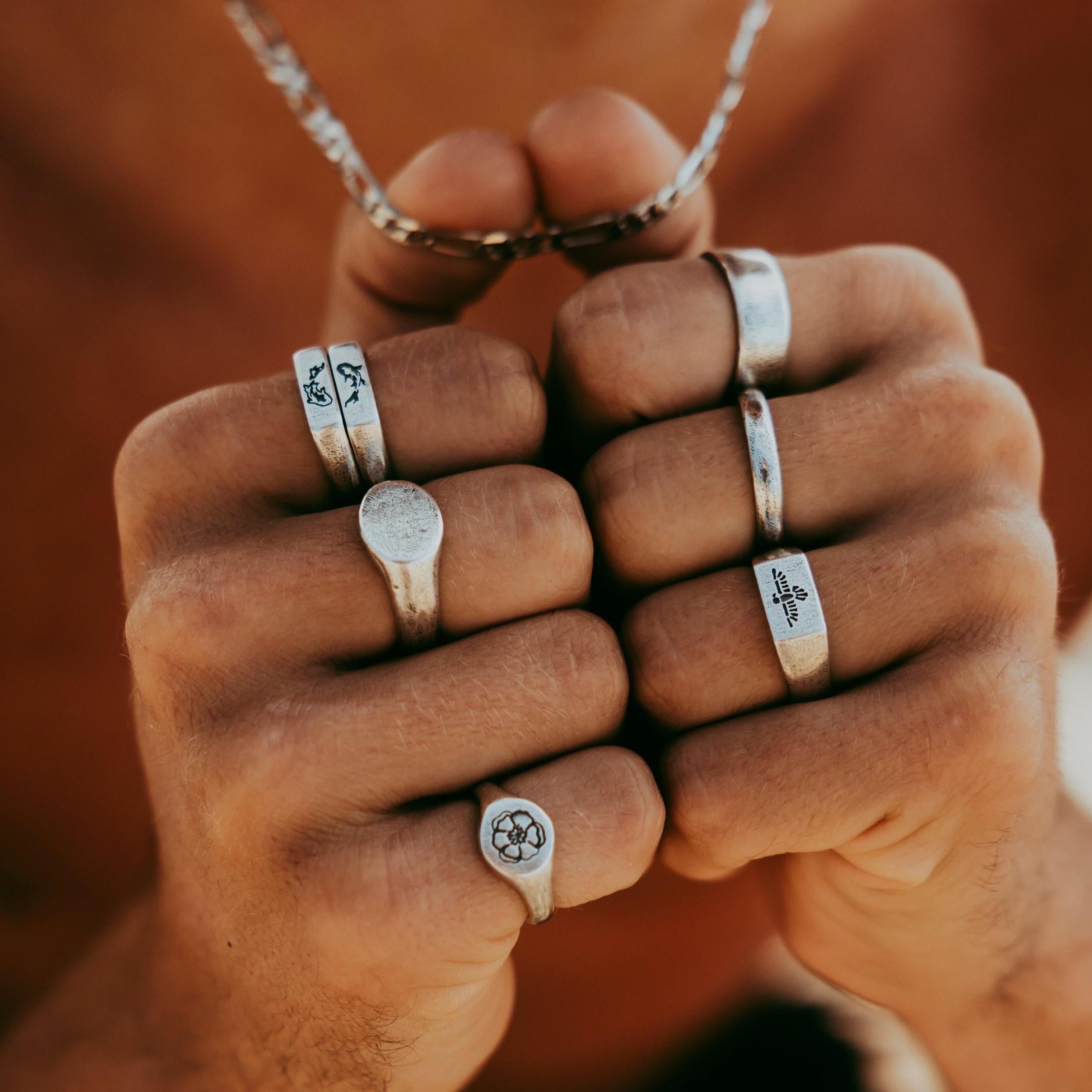 The Billie Jo Solace Ring styled on a model's hand, demonstrating how this sterling silver signet ring can be worn daily. Australian men's jewellery brand.