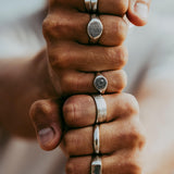 Lifestyle image of a man wearing the Solace Ring and other silver jewellery from Billie Jo, with a focus on the hand and ring details.