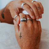 A man's hands with multiple rings, including the Billie Jo Revival Ring on the middle finger. A lifestyle shot showing how the ring can be styled.