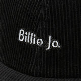 A close-up detail shot of the white embroidered 'Billie Jo' logo on the black corduroy fabric of the Corduroy Hat. Australian men's jewellery brand.