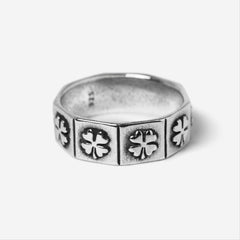 A studio shot of the Billie Jo LUCKY RING. This men's sterling silver ring has a unique geometric band with an embossed four-leaf clover pattern.
