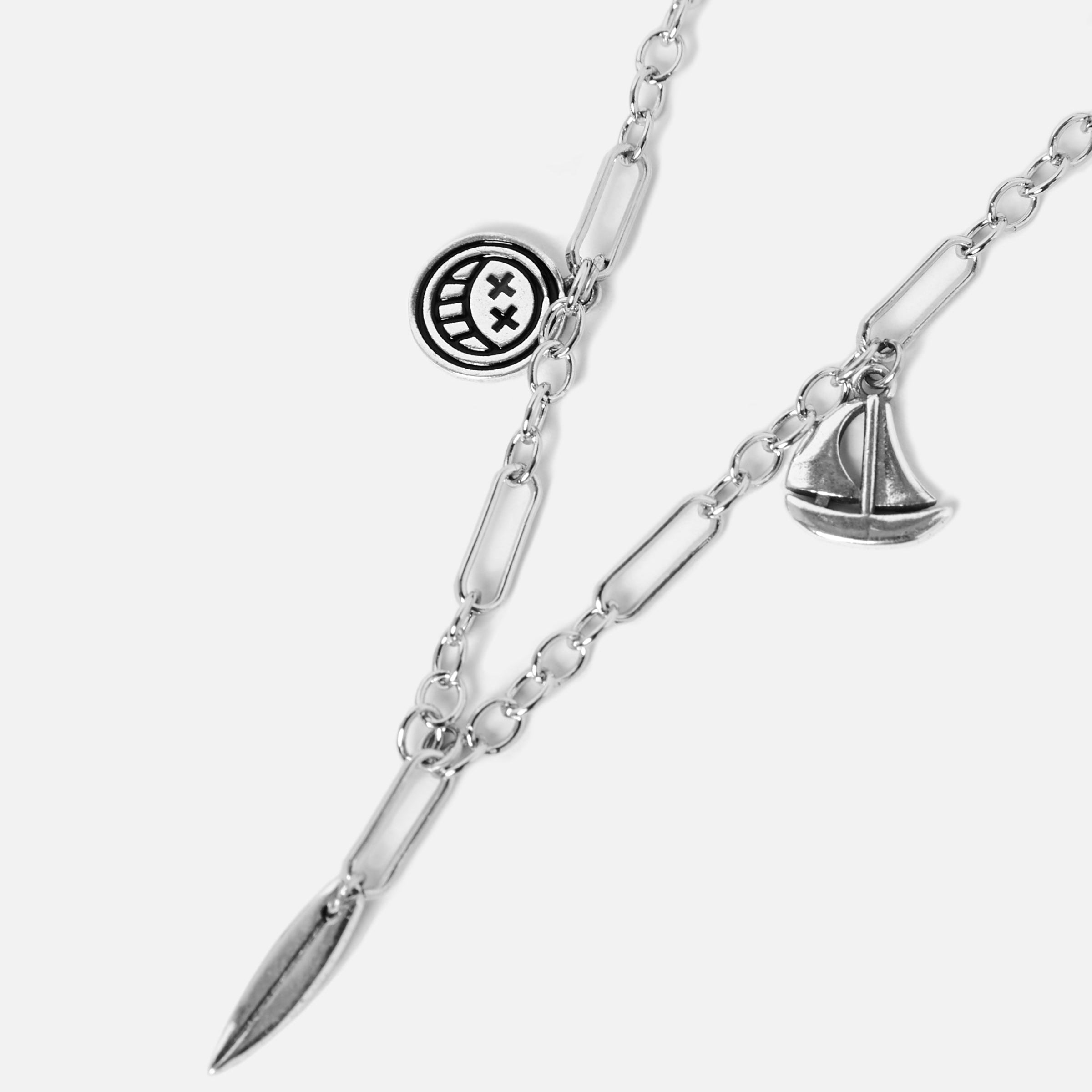 Billie Jo's sterling silver Freedom Necklace, featuring a paperclip chain with unique smiley face, sailboat, and feather pendants for a modern, masculine look.