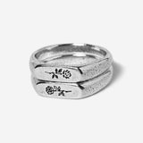 A set of two sterling silver Rosa Stacker rings from Billie Jo, featuring a delicate, engraved rose design on each ring for a subtle, masculine look.