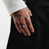 The Elaris Ring by Billie Jo, a sterling silver butterfly ring, seen on a tattooed hand. A subtle yet stylish piece of Australian men's jewellery.