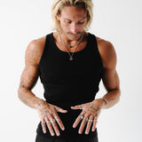 A model with tattoos wears the Billie Jo Eclipse Necklace layered with other silver chains, showcasing a modern, masculine jewellery look.