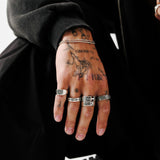 The Elaris Ring from Billie Jo, a sterling silver butterfly ring, styled with other rings for a complete men's jewellery look. Modern, masculine, and Australian-designed.