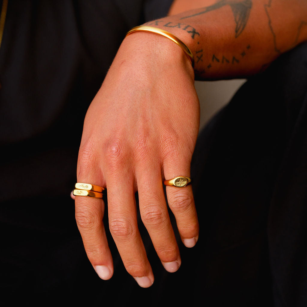 A final look at the Billie Jo Rosa Stacker rings in gold, worn on a man's hand to showcase their unique design and premium quality for men's jewellery.
