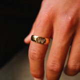 The 18k gold vermeil Revival Ring by Billie Jo, held in hand to display its size and scale. The image captures the quality craftsmanship of this Australian-designed men's ring.