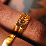 A close-up on-hand shot of the men's gold Koi Stackers rings by Billie Jo, showing the detailed koi fish engraving and the 18k gold vermeil finish.