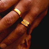 Detailed on-hand shot of the Billie Jo Koi Stackers rings in gold, showing the texture of the engraved koi fish and the polished 18k gold vermeil band.