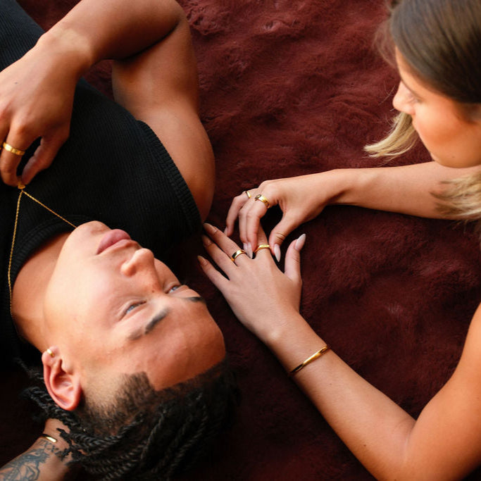 An editorial campaign shot for Billie Jo featuring a man and woman, both wearing pieces from the collection, including the gold Rosa II Ring.