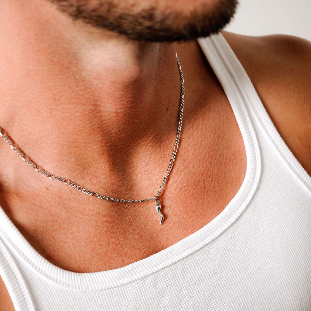A close-up lifestyle image of the Billie Jo Chilli Pendant in sterling silver, worn by a bearded man, showcasing its everyday style and modern appeal.