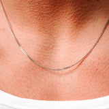 A close-up of the Billie Jo Curb Necklace, showing the fine craftsmanship of the 925 sterling silver links as it rests on the wearer's collarbone.