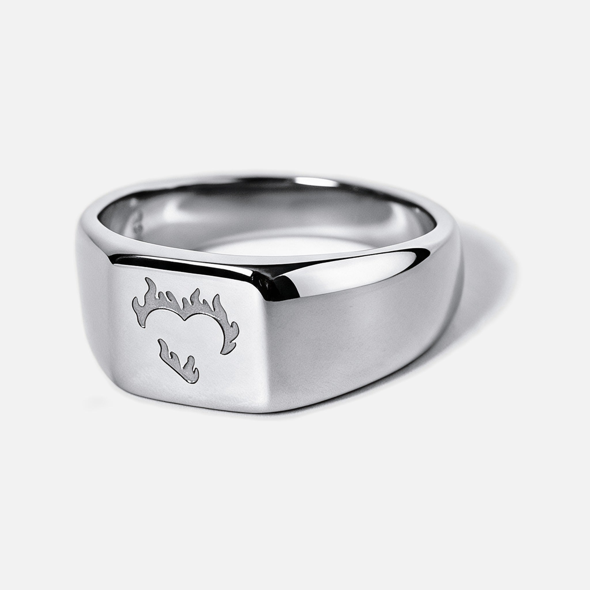 Men's Ember Ring in 316L stainless steel, silver finish, angled view of the flaming heart on the square face
