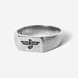 A sterling silver Essence Ring by Billie Jo, featuring a textured finish and a unique bird-like engraving on its face, shot against a clean white background.