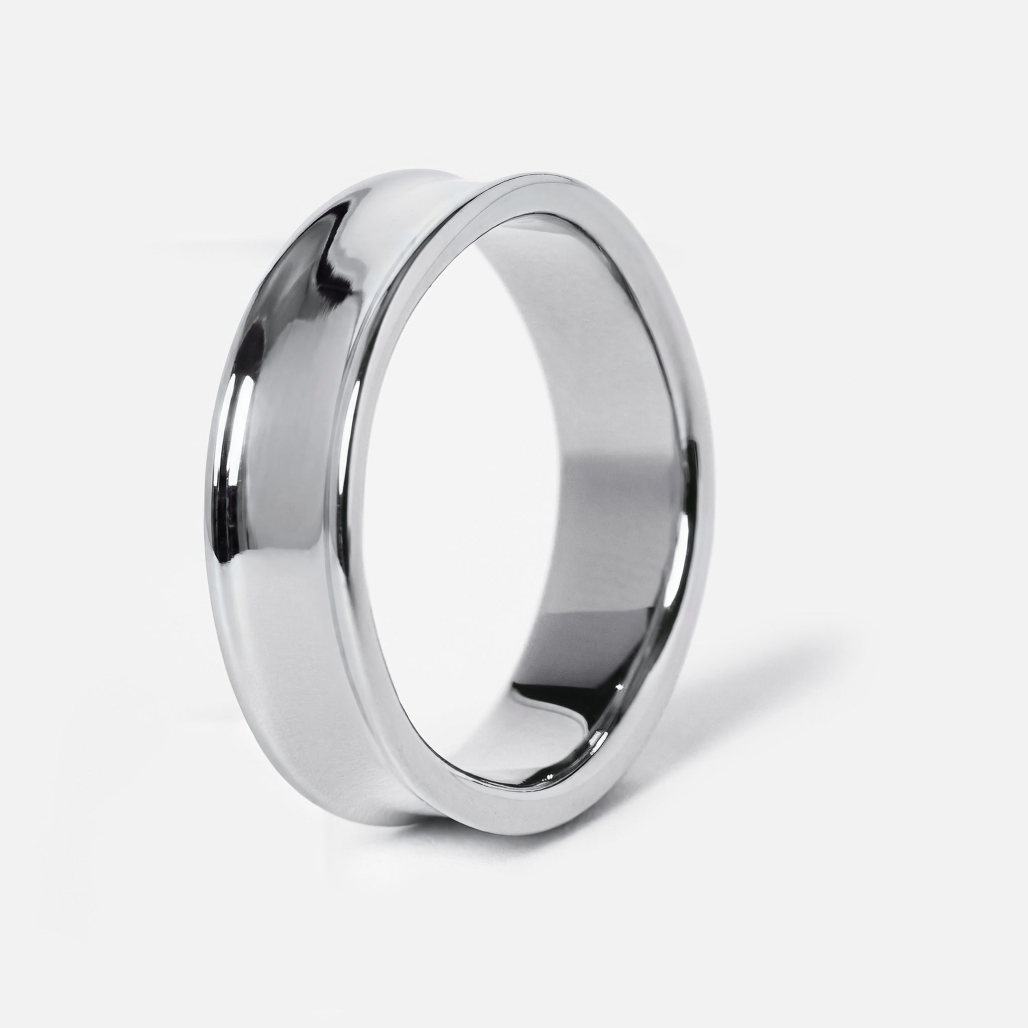 Men's Forge Ring in 316L stainless steel, silver finish, angled side view showing the dished band and raised edges
